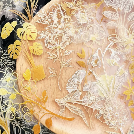 Decorative floral and leaf cutouts on a wooden board.