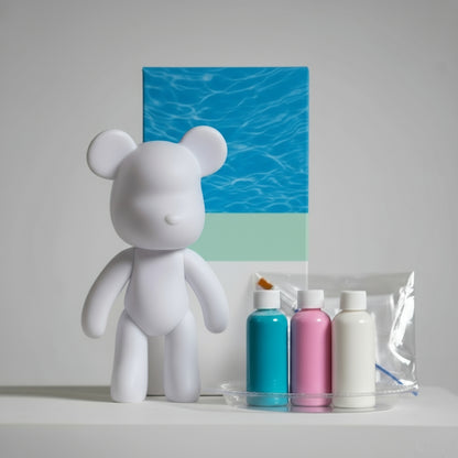 White bear figurine with Bear Build products on a gray surface